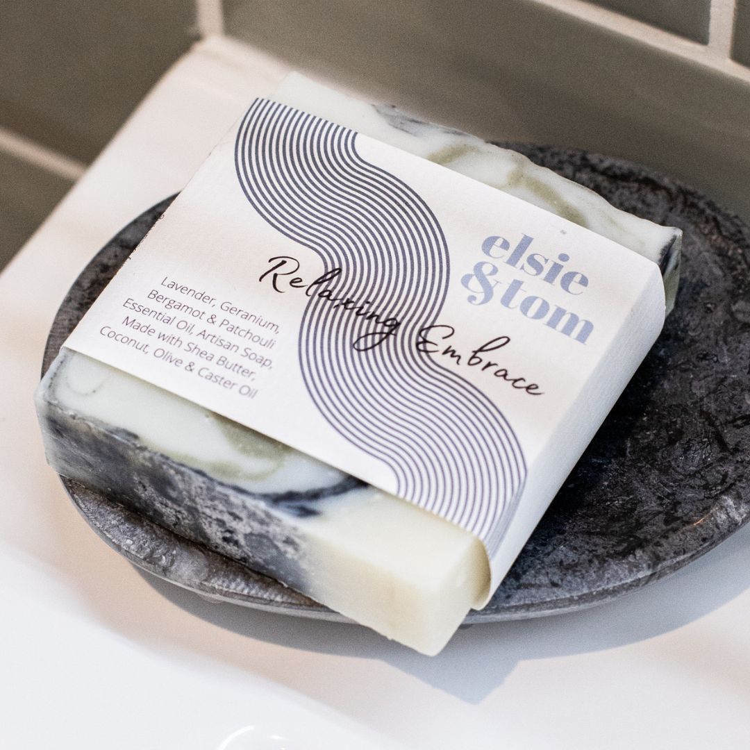 Bar of soap with packaging labeled 'elsie & Tom on a textured surface.